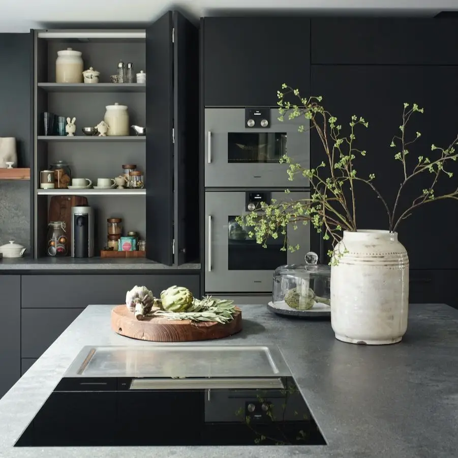 Modern dark kitchen with matte black cabinetry, sleek countertops, built-in appliances, and minimalist luxury design for a contemporary South Bay home.